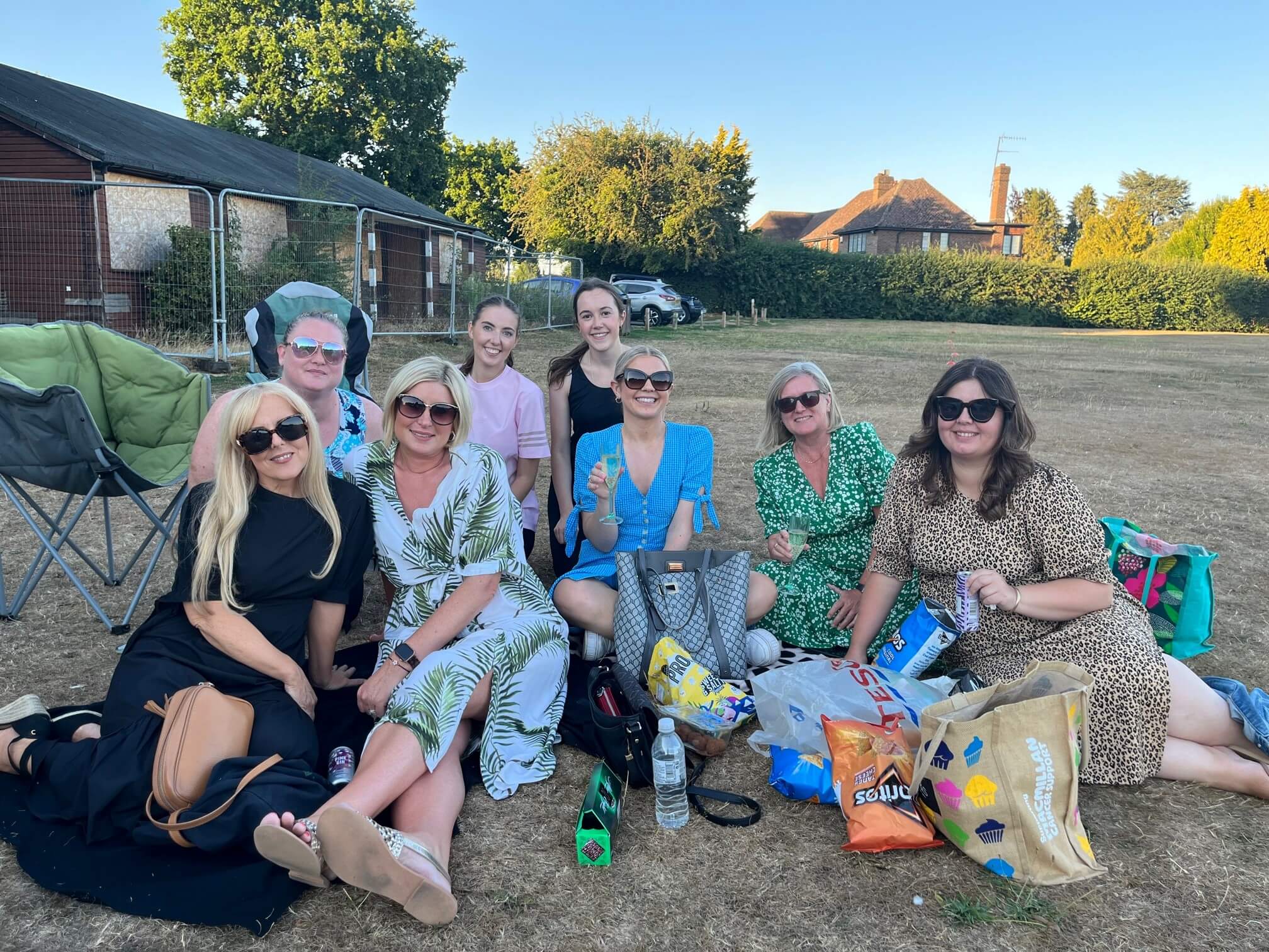 Team members relaxing on the grass in a park